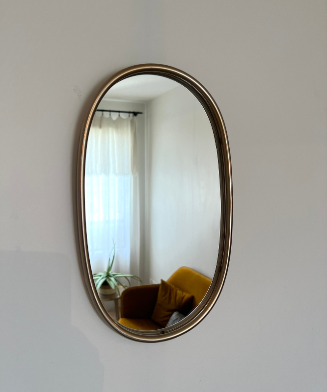 Miroir mural ovale doré